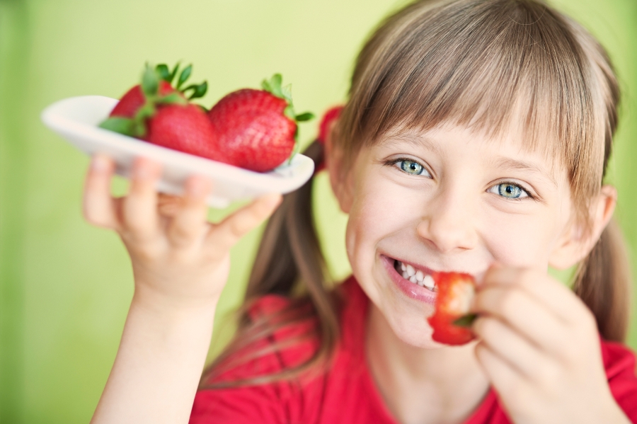 girl eating strawberry